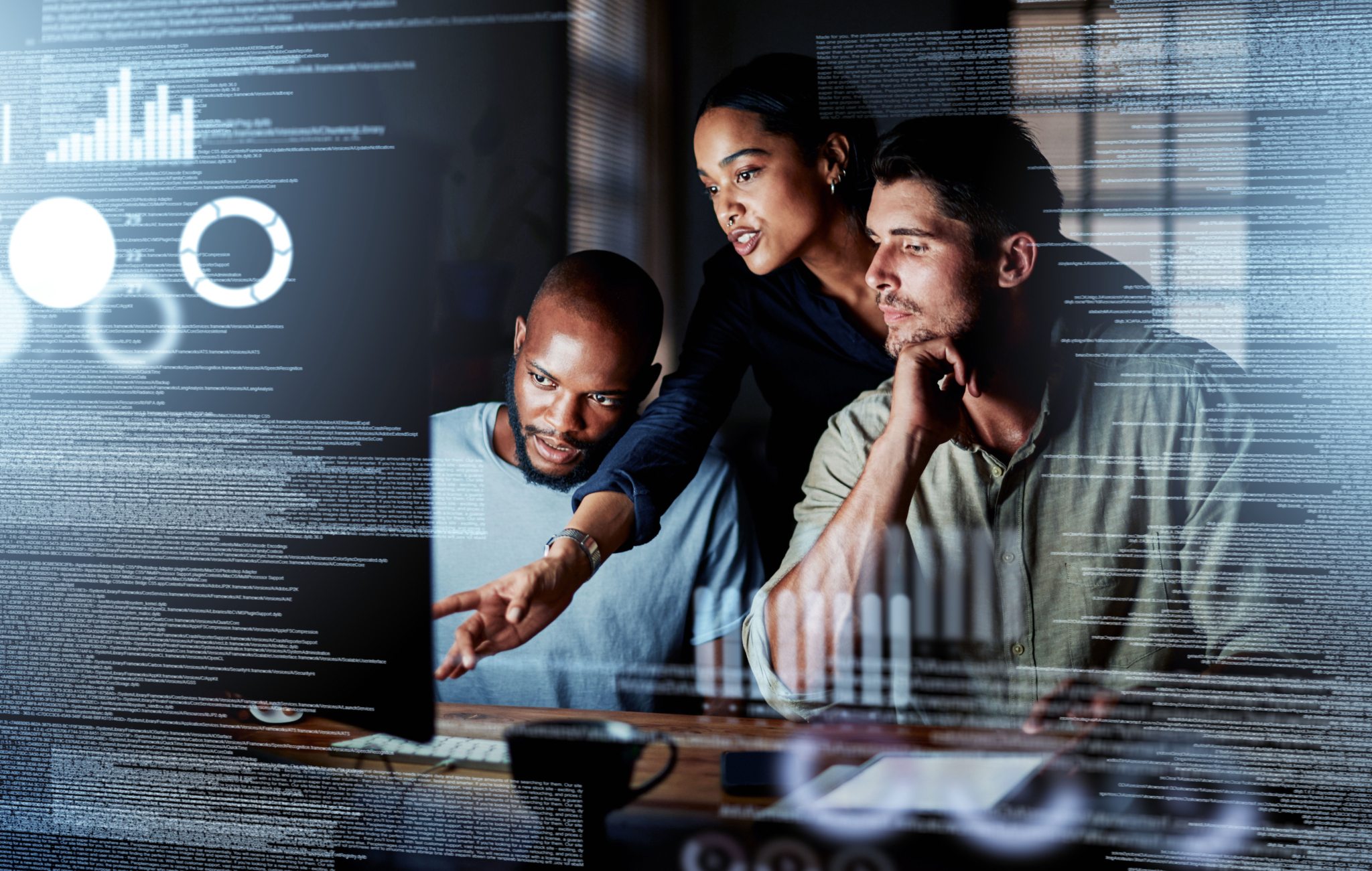 Team reviewing code and data on a computer screen.